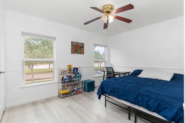 bedroom with light wood-type flooring and ceiling fan