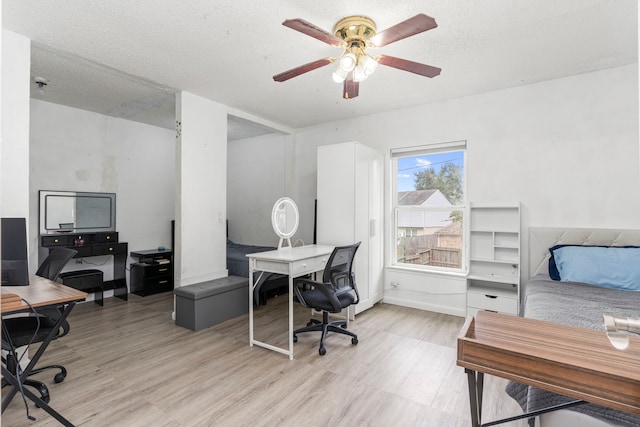 office space featuring a textured ceiling, ceiling fan, and light hardwood / wood-style floors