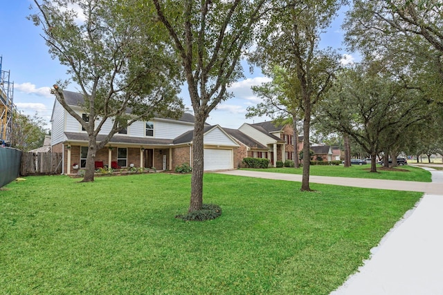 view of front of home featuring a front yard and a garage