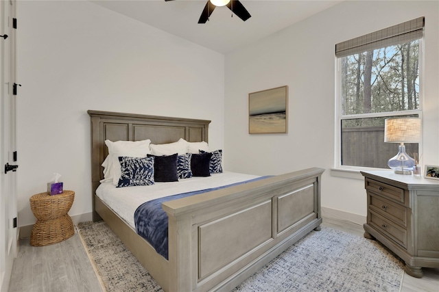 bedroom with light wood-type flooring and ceiling fan