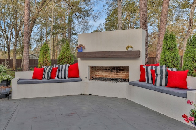 view of patio with an outdoor living space with a fireplace