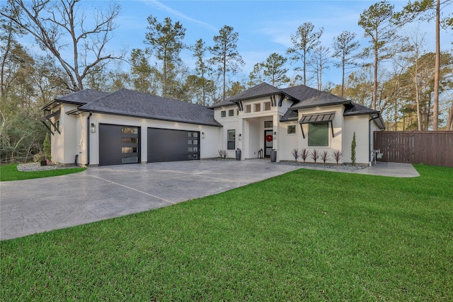 prairie-style home with a front lawn and a garage