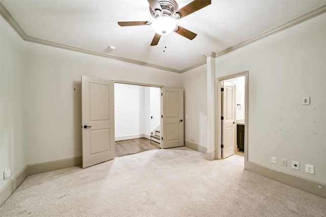 unfurnished bedroom with ornamental molding, ceiling fan, connected bathroom, and light colored carpet