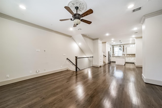 unfurnished living room with ceiling fan, dark wood-type flooring, and crown molding