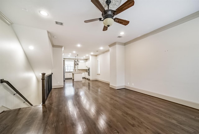 unfurnished living room with ornamental molding, ceiling fan, and dark hardwood / wood-style floors