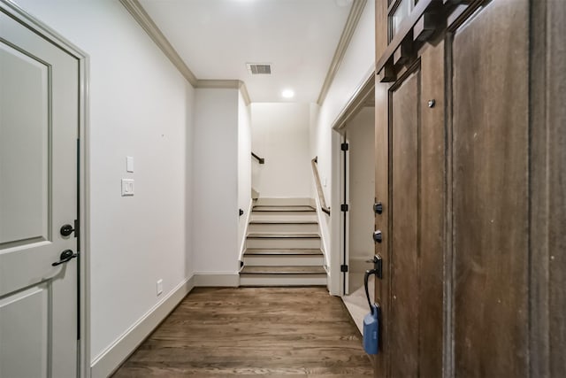 doorway with ornamental molding and dark hardwood / wood-style flooring