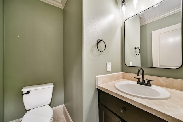 bathroom with toilet, crown molding, and vanity