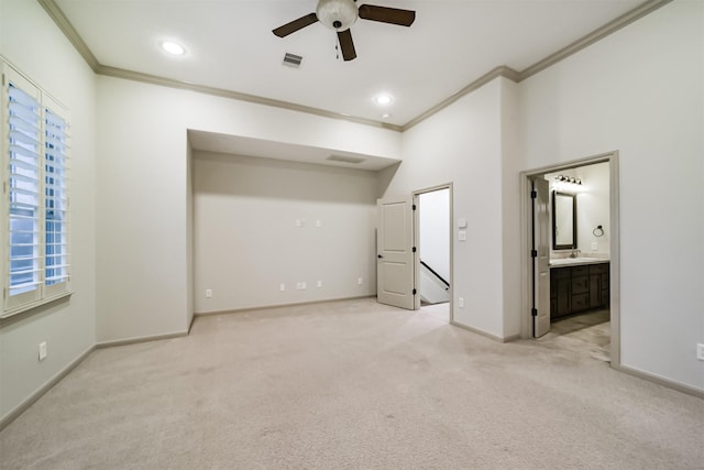 unfurnished bedroom featuring ensuite bath, ceiling fan, light carpet, and ornamental molding