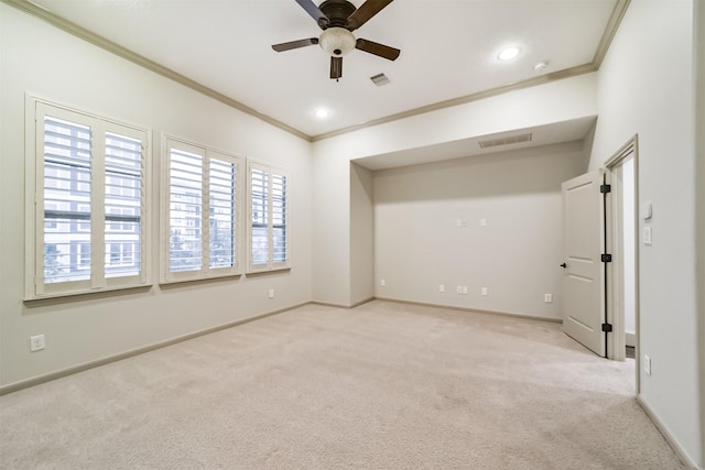 carpeted empty room featuring ceiling fan, ornamental molding, and a healthy amount of sunlight