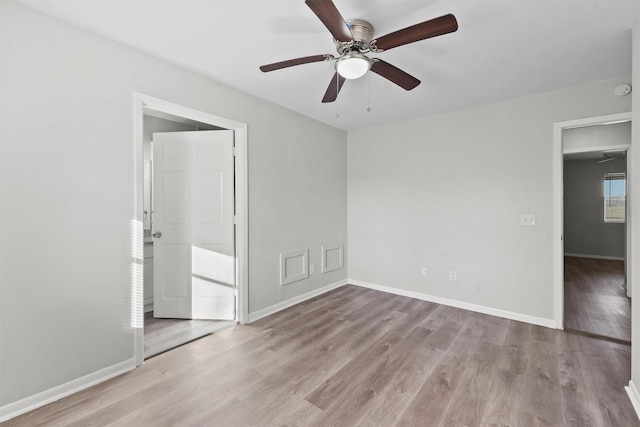 unfurnished room featuring light wood-style floors, baseboards, and a ceiling fan