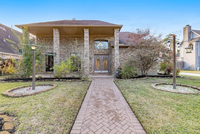 view of front of home featuring a front yard and french doors