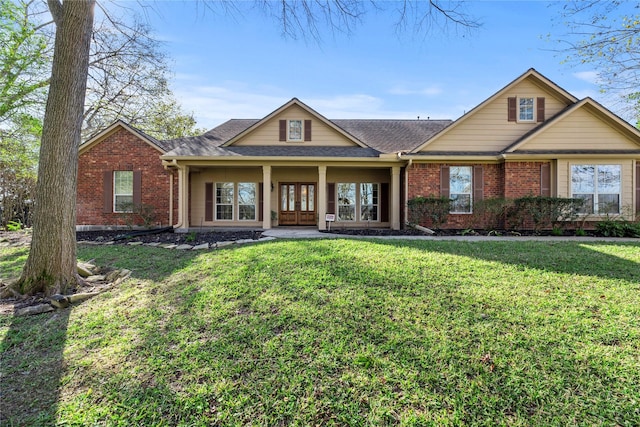 view of front of home with french doors and a front lawn