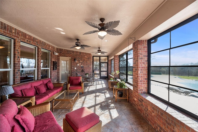 sunroom featuring ceiling fan