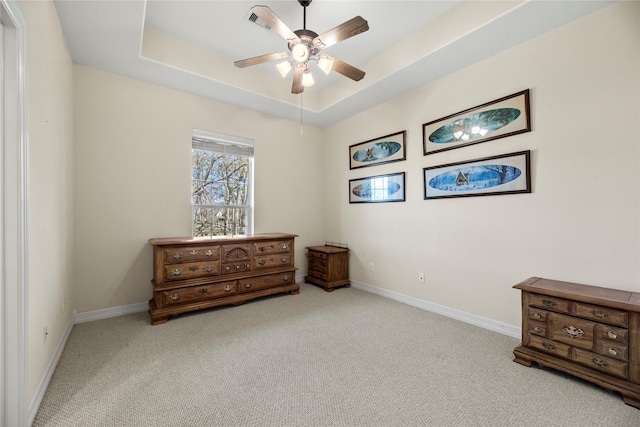 interior space with ceiling fan and a tray ceiling