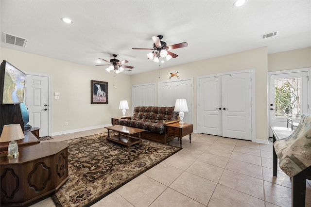 living room with ceiling fan and light tile patterned flooring