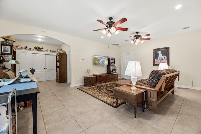 living room featuring light tile patterned flooring and ceiling fan