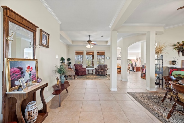 foyer entrance with crown molding, ceiling fan, and light tile patterned floors