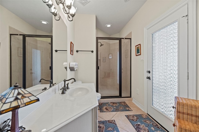 bathroom featuring an inviting chandelier, a shower with shower door, toilet, tile patterned floors, and vanity