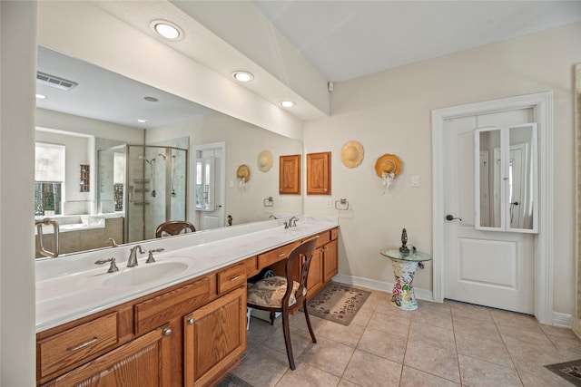 bathroom with tile patterned floors, walk in shower, and vanity