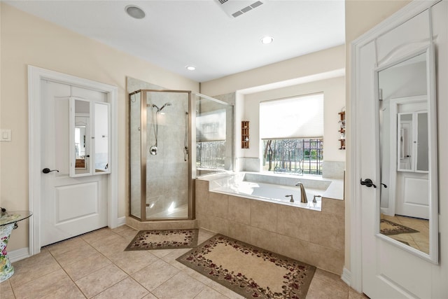 bathroom featuring tile patterned floors and independent shower and bath