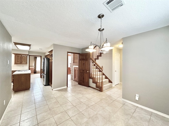 interior space featuring a chandelier and light tile patterned floors