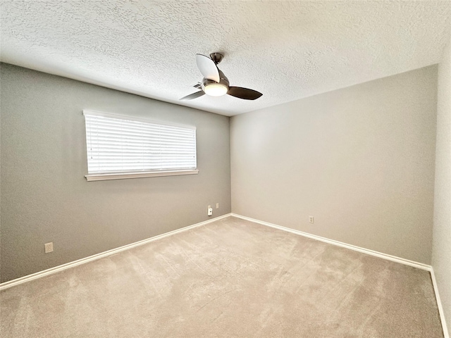 carpeted empty room with ceiling fan and a textured ceiling