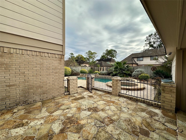 view of patio featuring a pool with hot tub