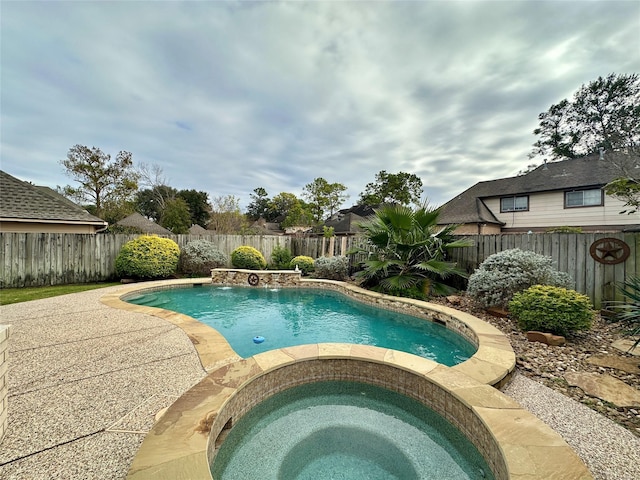 view of swimming pool featuring pool water feature and an in ground hot tub