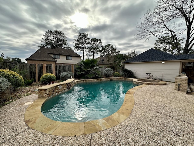 view of pool with a patio area and an in ground hot tub