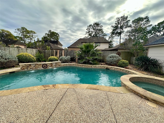 view of pool with pool water feature and an in ground hot tub