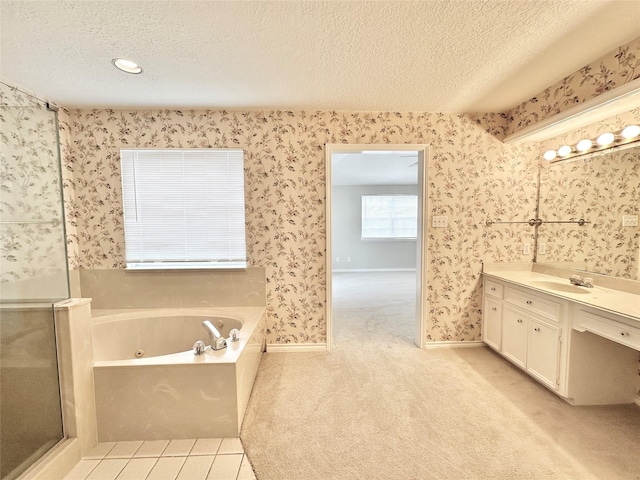 bathroom featuring tile patterned flooring, a textured ceiling, a bathtub, and vanity