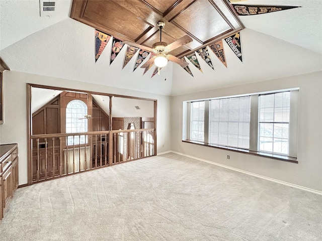 unfurnished living room featuring ceiling fan, light colored carpet, and vaulted ceiling