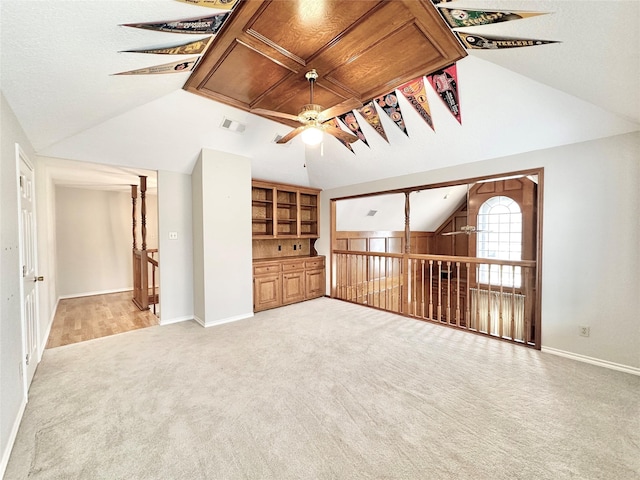 interior space featuring ceiling fan, light carpet, and vaulted ceiling