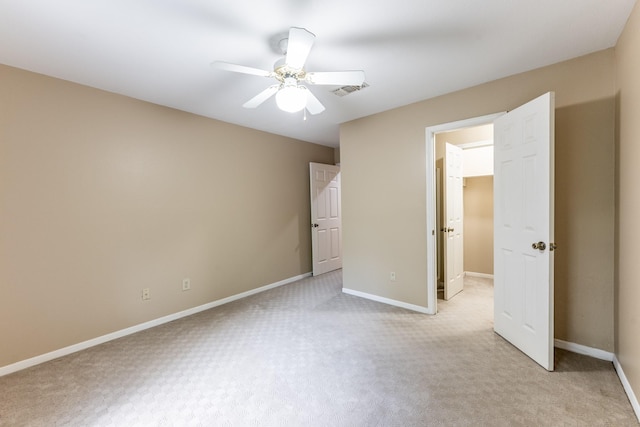 unfurnished bedroom with ceiling fan and light colored carpet