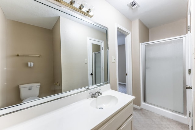 bathroom featuring an enclosed shower, vanity, and toilet