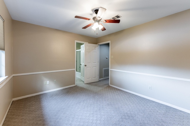 spare room with ceiling fan and carpet flooring