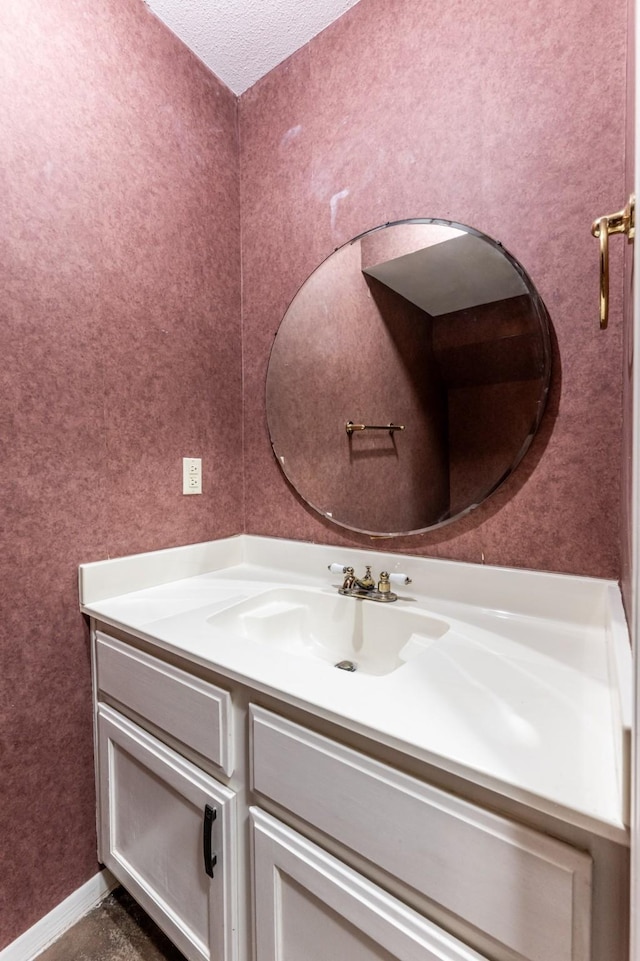 bathroom with vanity and a textured ceiling