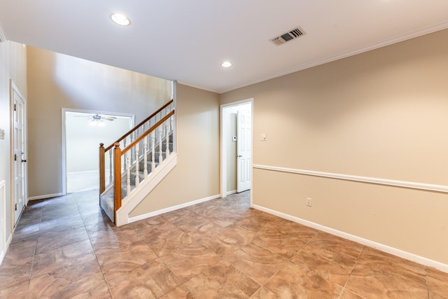 unfurnished room with ceiling fan and ornamental molding