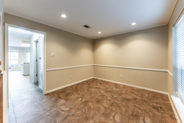 empty room featuring crown molding