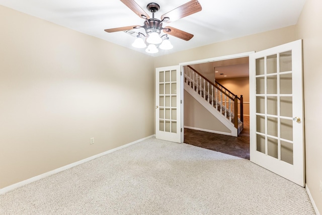 spare room featuring french doors, carpet floors, and ceiling fan