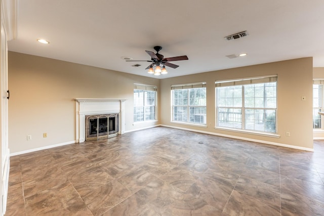 unfurnished living room with ceiling fan and plenty of natural light