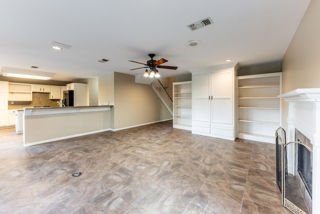 unfurnished living room with ceiling fan