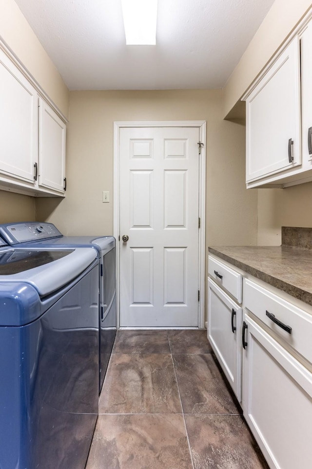 laundry room featuring cabinets and washer and clothes dryer