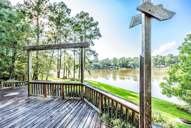 wooden terrace featuring a water view