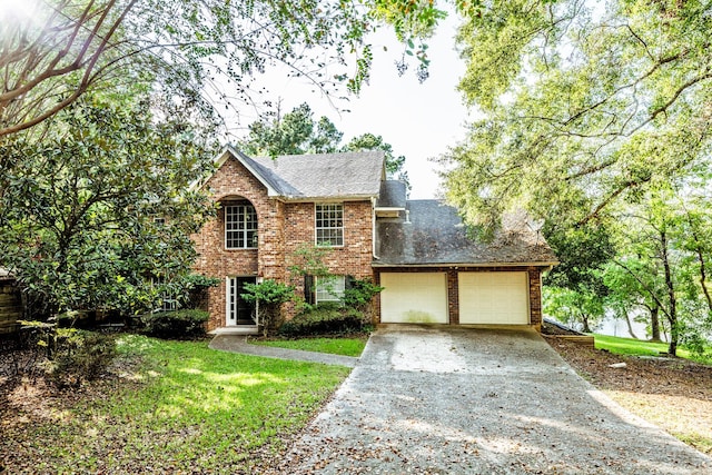 view of front of house featuring a front lawn and a garage