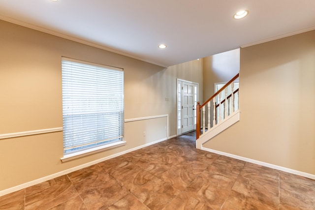 unfurnished room with crown molding