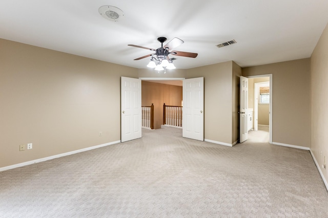 unfurnished room featuring light carpet and ceiling fan