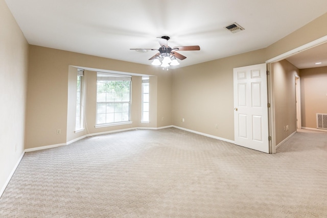 unfurnished room featuring light colored carpet and ceiling fan