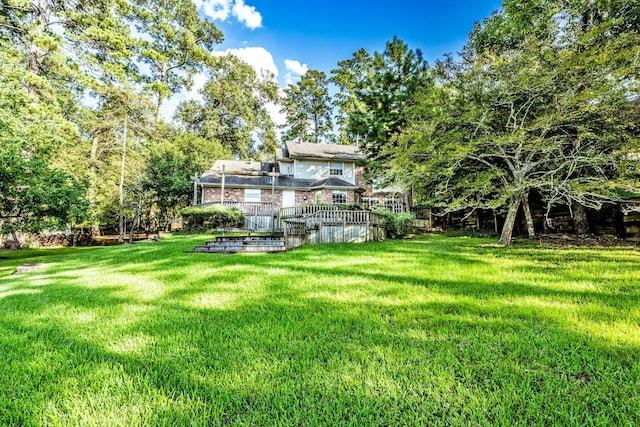 1915 E Lake Dr, Huntsville, TX 77340 - view of grassy yard with a deck