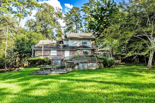 1915 E Lake Dr, Huntsville, TX 77340 - rear view of property featuring a lawn, brick siding, and a wooden deck